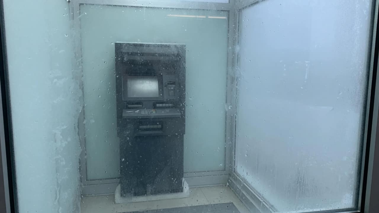 כספומט מאחורי זכוכית בבוקר (בעזרת AI)